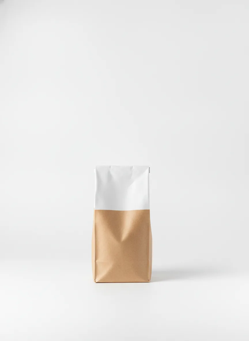 A sealed First Crack coffee bag standing upright on a pale seamless surface under soft studio light
