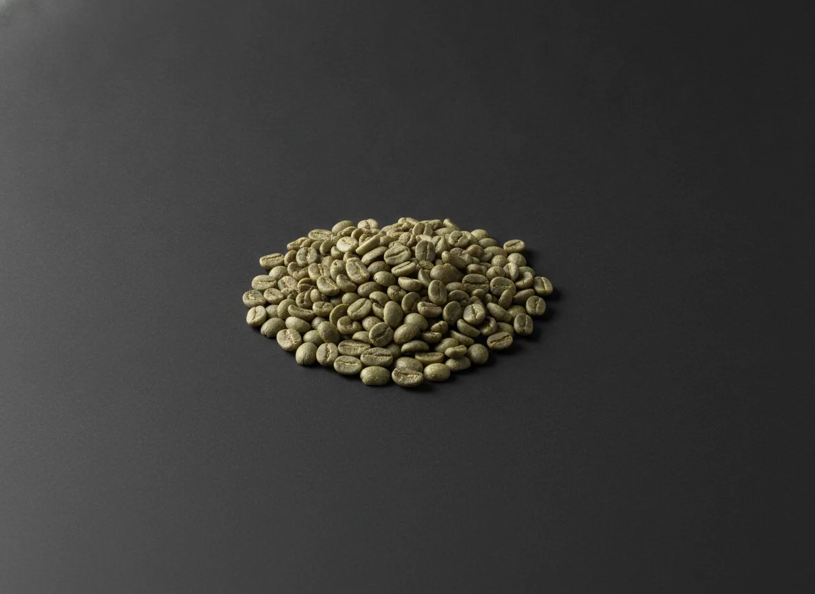 A handful of raw green unroasted coffee beans resting on a deep charcoal seamless surface, evenly lit