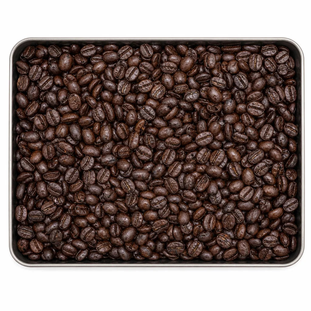 Dark, oily dark-roast Kerinci beans in a shallow steel tray.