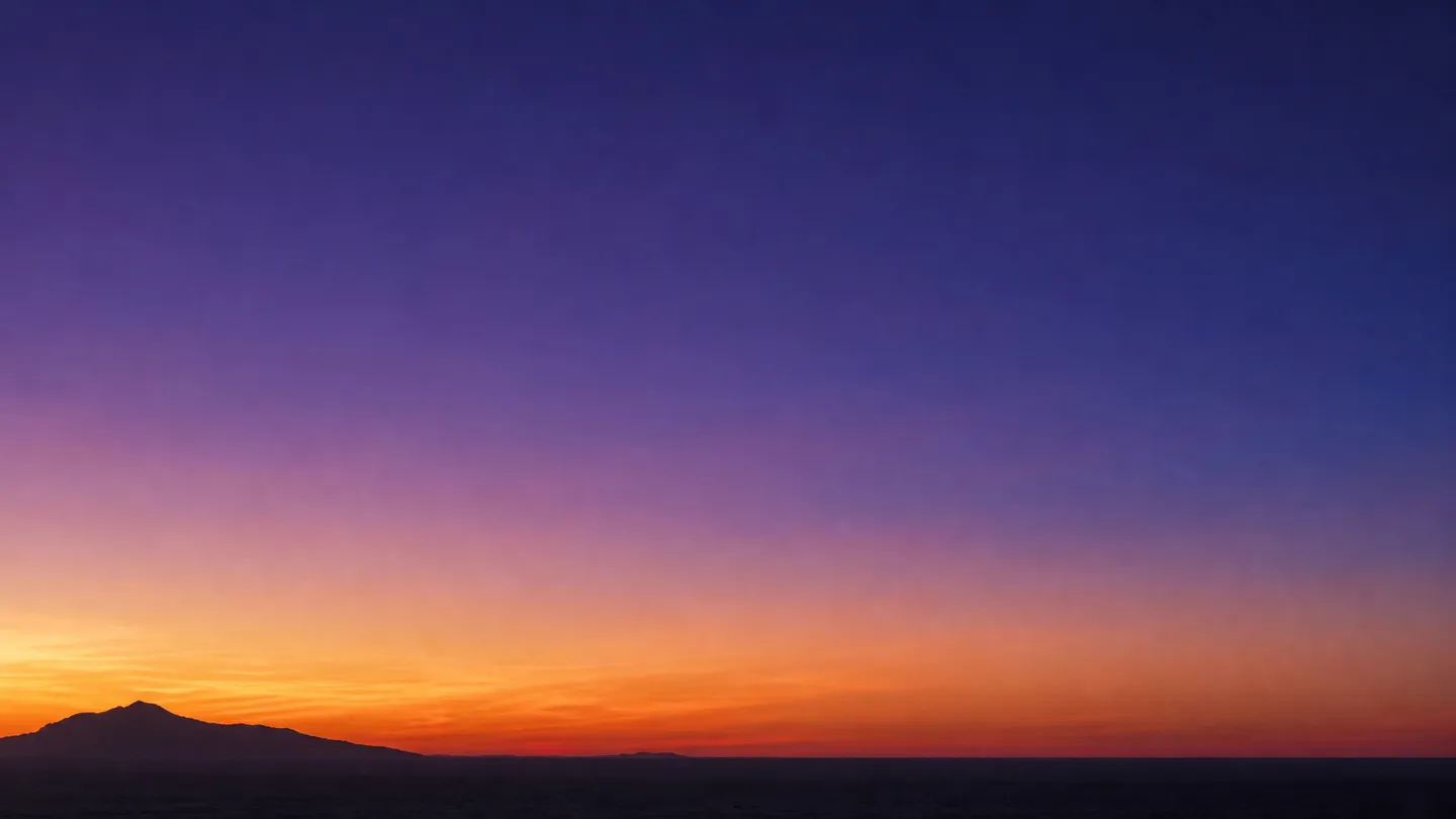 A saturated dusk gradient sky over a low horizon