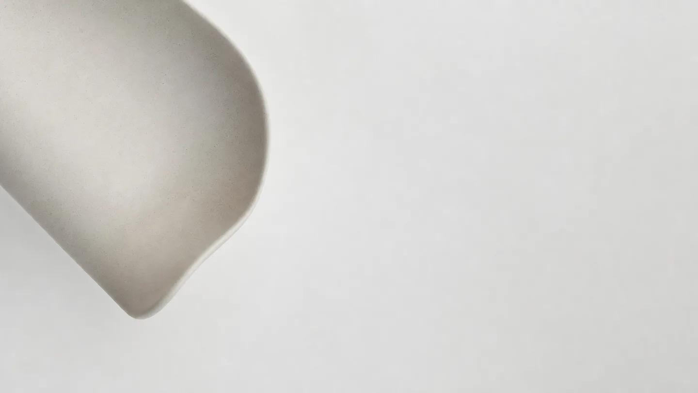 Overhead view of a curved form entering the frame from a corner