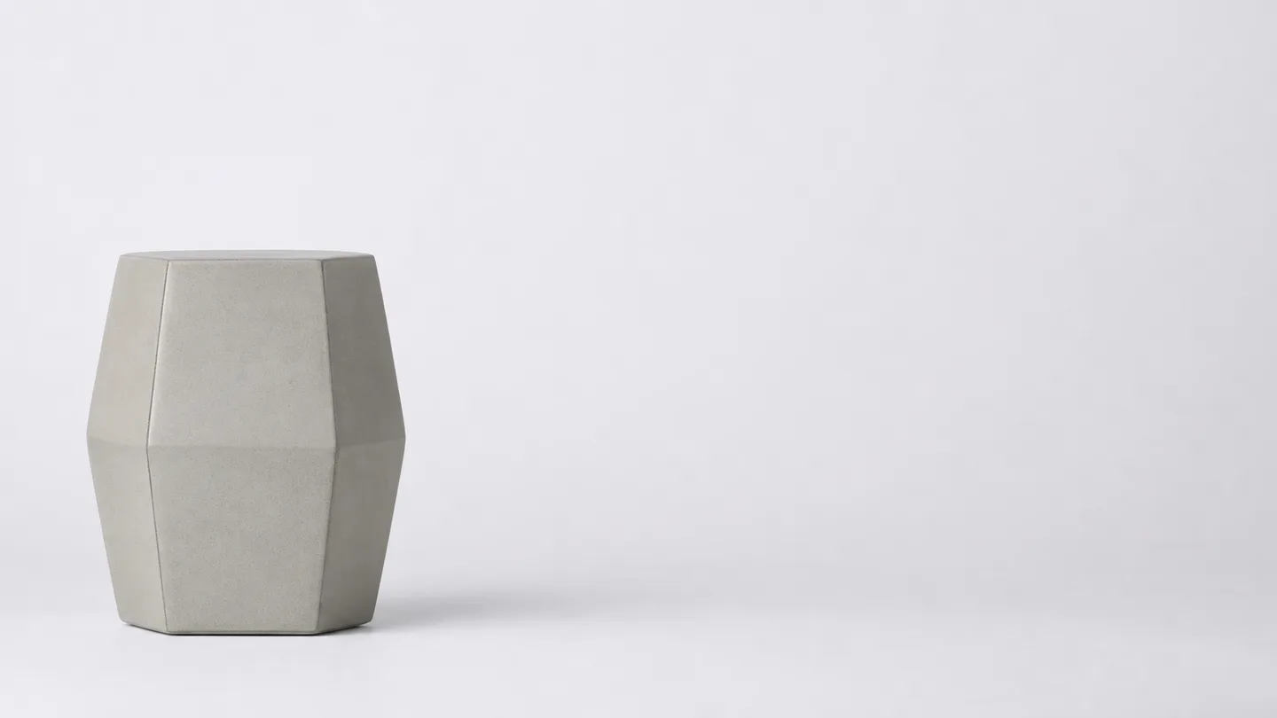 Smooth faceted studio object on a pale seamless background